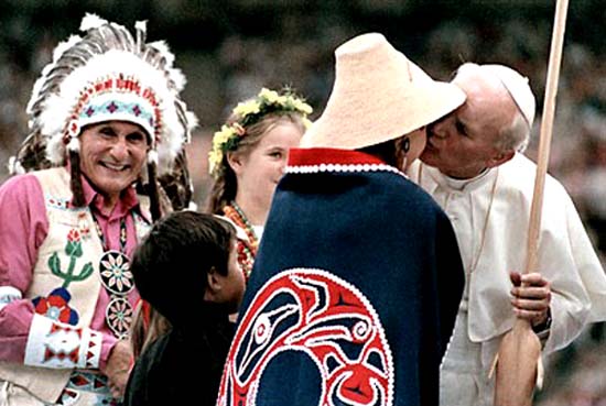 John Paul II kissing a young woman dressed in American Indian garb